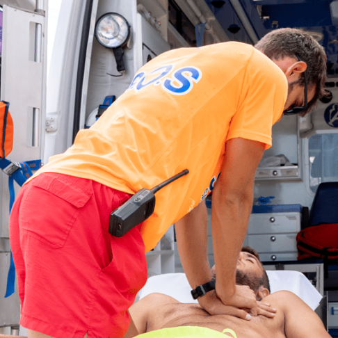 lifeguard-performing-cardiopulmonary-resuscitation-cpr-man-top-ambulance-stretcher
